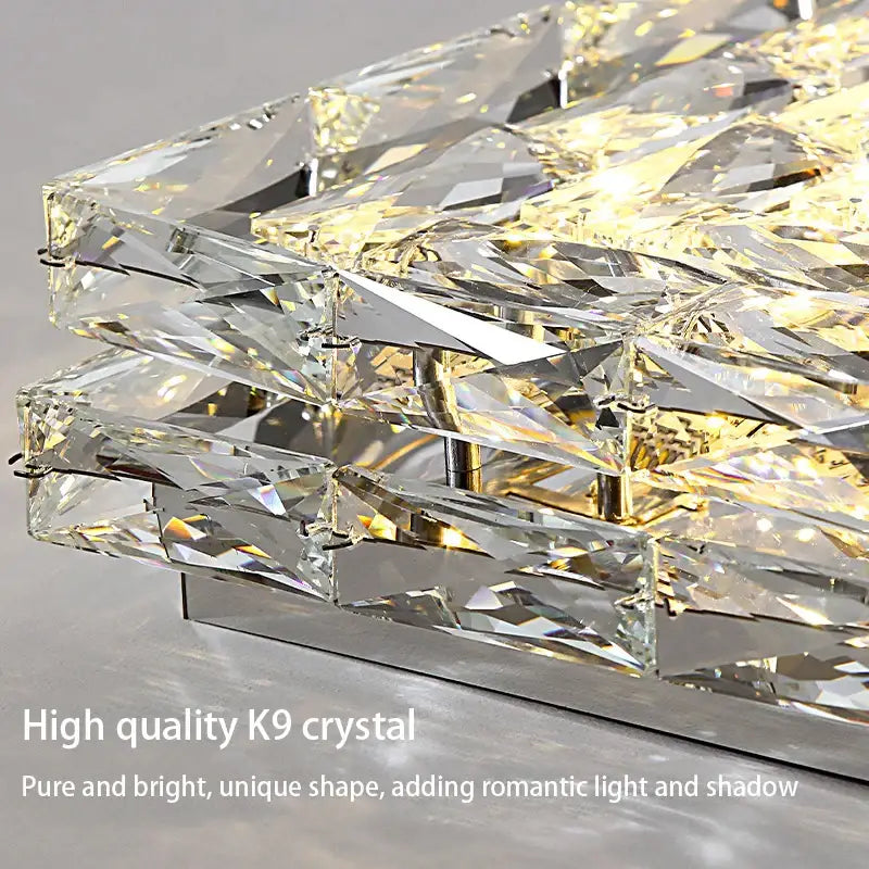 A modern rectangular crystal led ceiling chandelier with layered faceted k9 crystals refracting warm light decorbites crystal led