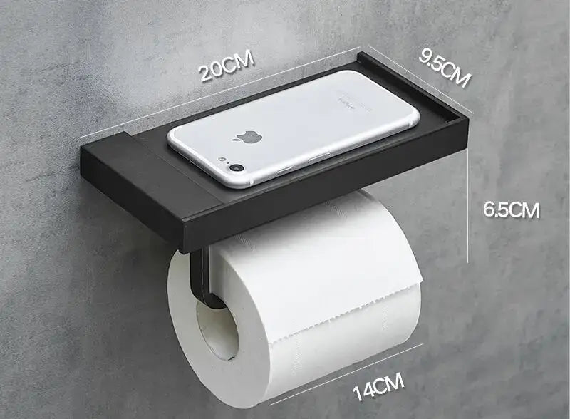 Modern rectangular black metal toilet paper holder with integrated tray holding a silver iphone for bathroom use