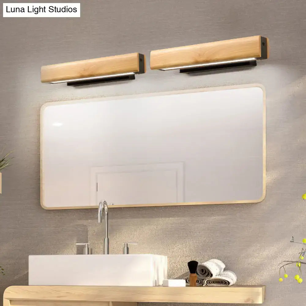 Two sleek rectangular wooden vanity lights with black metal bases mounted above a mirror modern led sconce fixture height