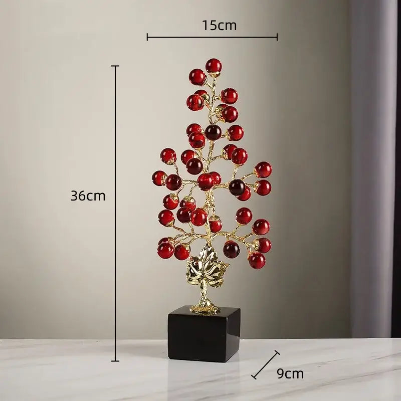 Modern red and gold grape vine metal sculpture with decorative glass berries on black pedestal for living room decorbites decor