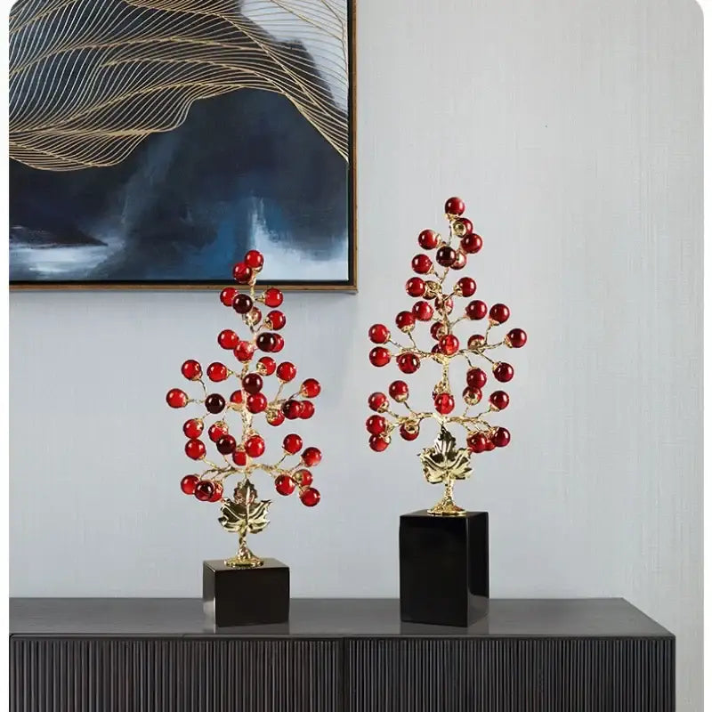 Two elegant gold-toned grape vine metal sculptures with red beads on black bases for modern decorbites grape vine decor