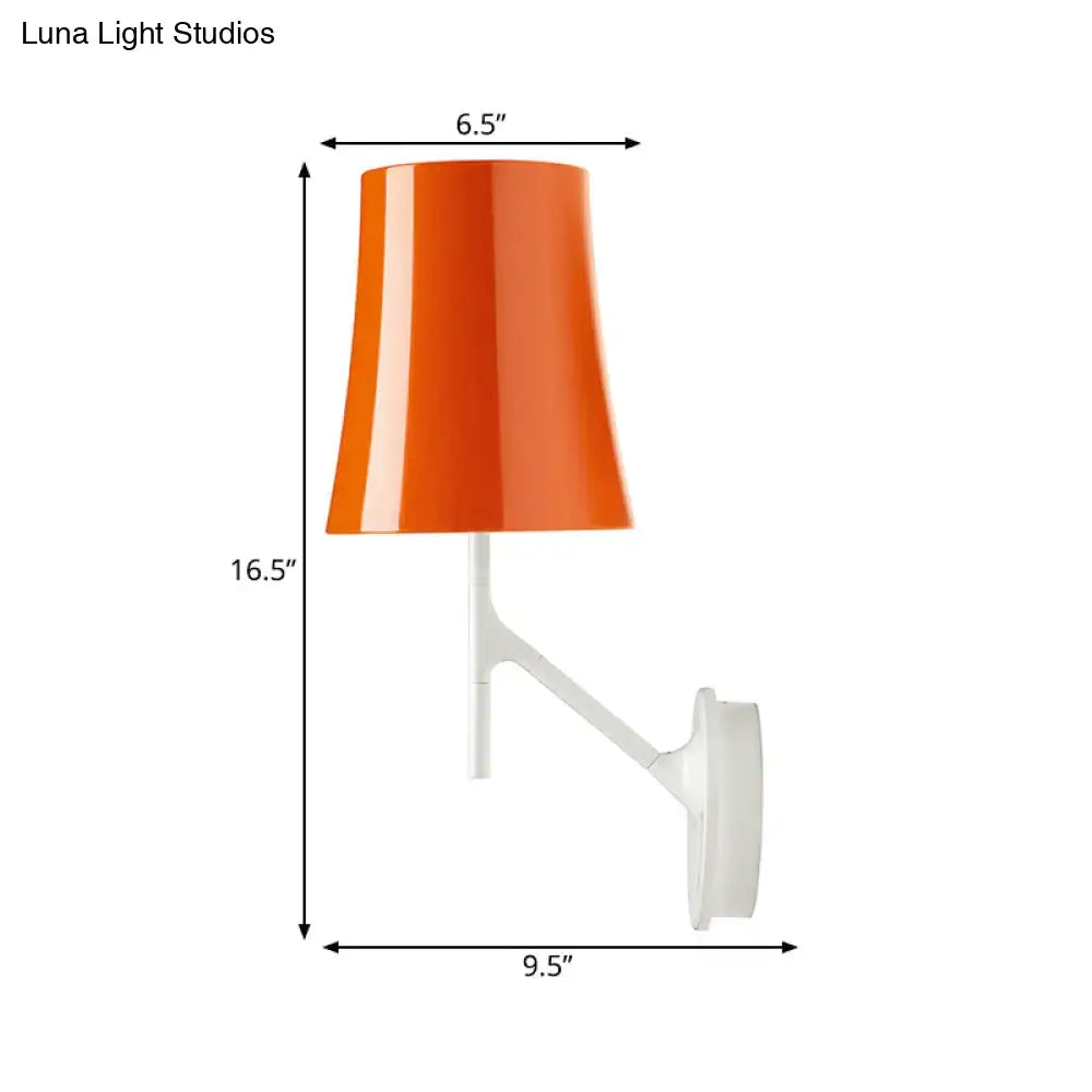 Vibrant orange metallic sconce with a glossy finish mounted on a sleek white barrel wall mount for living room lighting