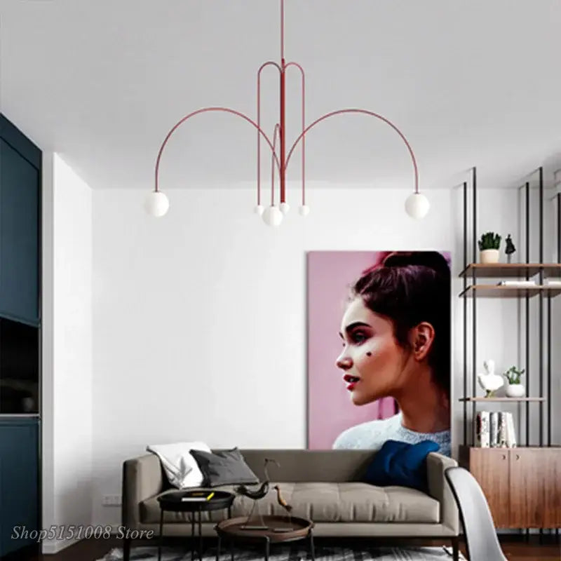 Modern red and white branch glass pendant lights featuring curved metal arms and spherical fixtures for living room decor