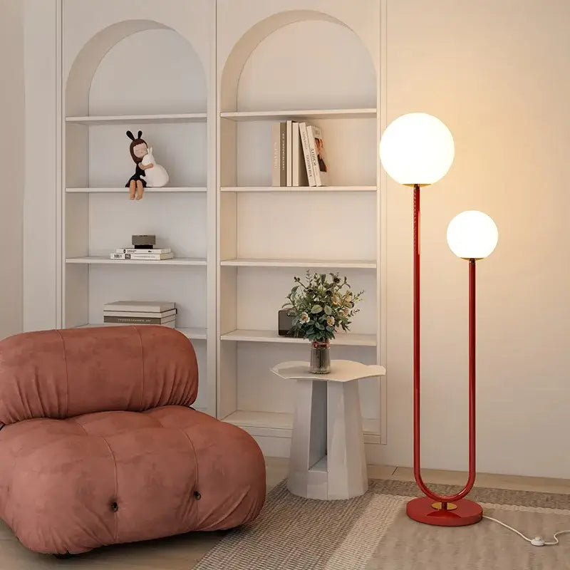 Modern red and white metal floor lamp with dual spherical glass shades and curved frame for living room decorbites black white