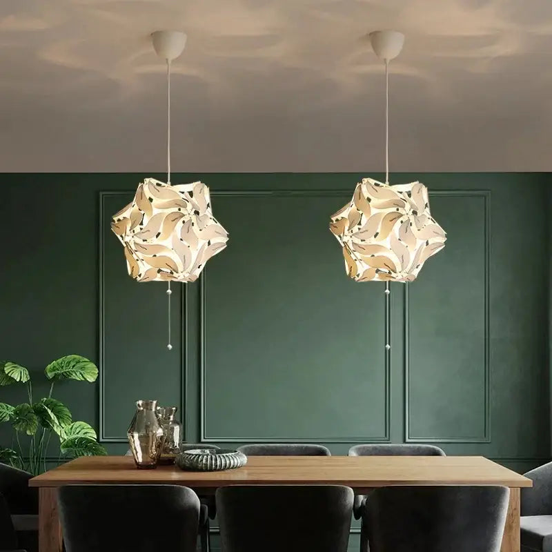 Two elegant off-white bauhinia flower chandeliers with intricate floral cutouts for modern living room lighting