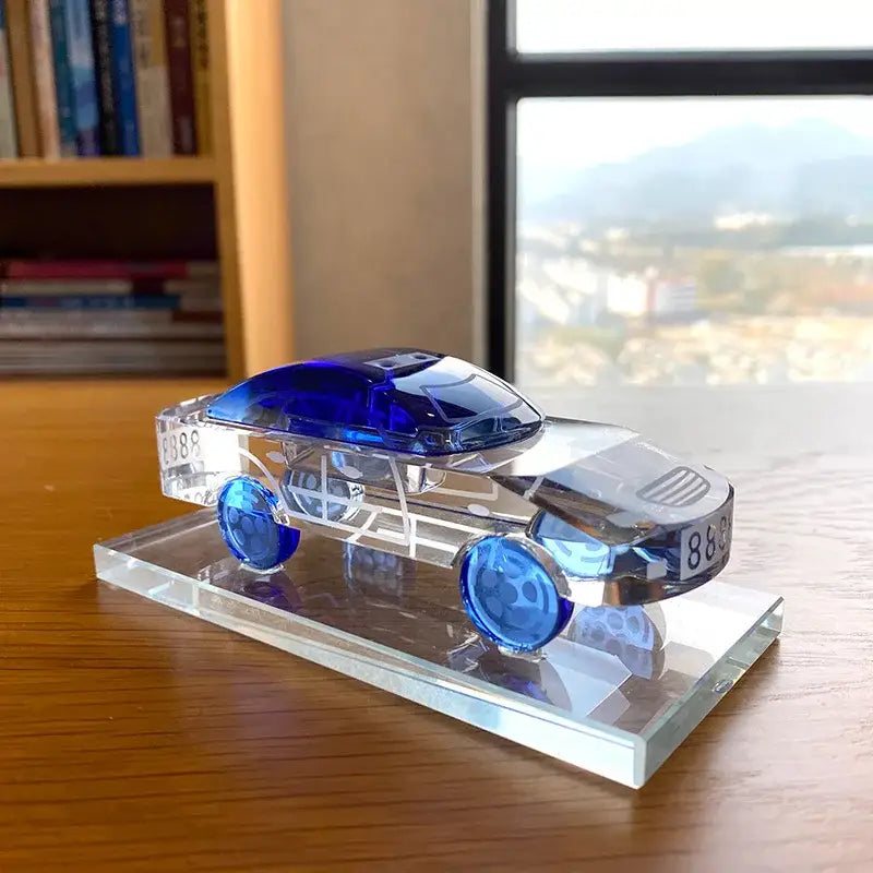 Modern red and blue crystal car model office table decor with a translucent blue and clear crystal car model on a transparent base