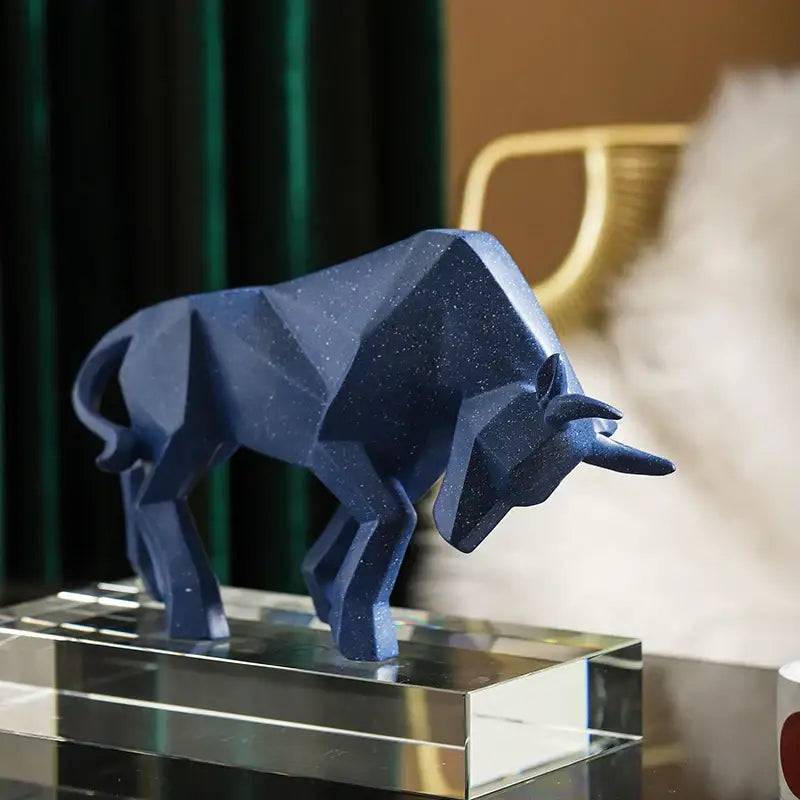 A sleek deep blue decorbites geometric bison sculpture with speckled finish on a crystal base for living room decor