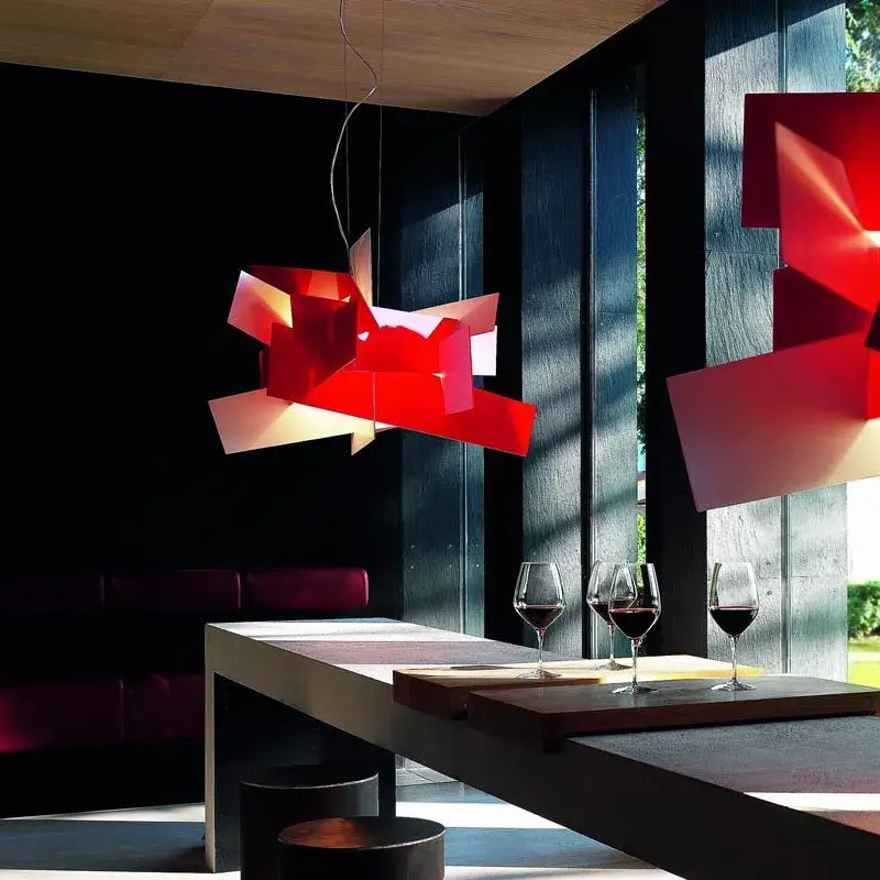 Modern red geometric acrylic leaf pendant lamp with vibrant angular panels suspended above dining table decorbites acrylic leaf pendant