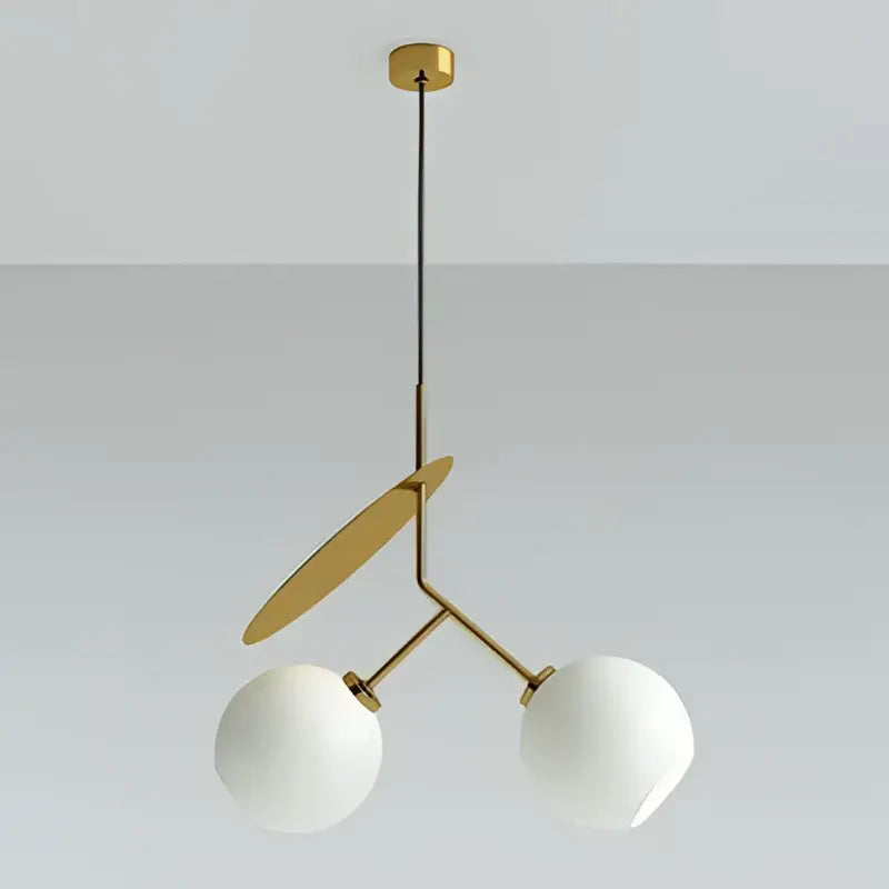 Modern gold-toned pendant light with two white glass spheres and flat circular accent for decorbites cherry led pendant