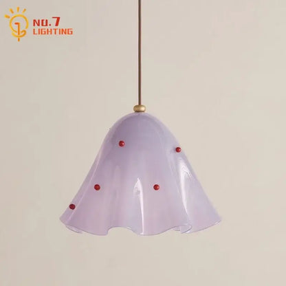 A delicate lavender glass pendant light with a fluted bell shade and red beads perfect for modern dining rooms