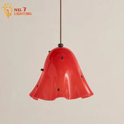 Modern red glass pendant light with black dots featuring a vibrant bell-shaped design and glossy finish for dining room