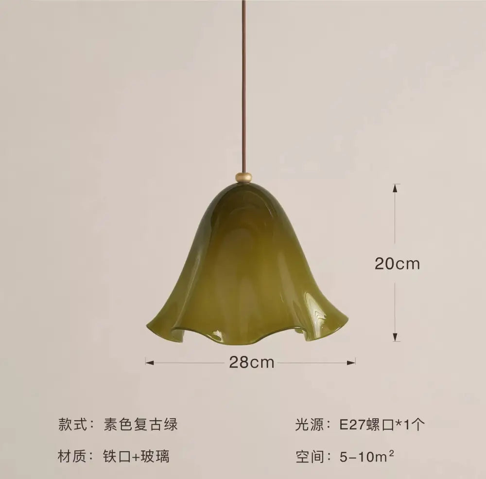 Olive-green bell-shaped glass pendant light with iron frame featuring modern red glass and black dots for dining room