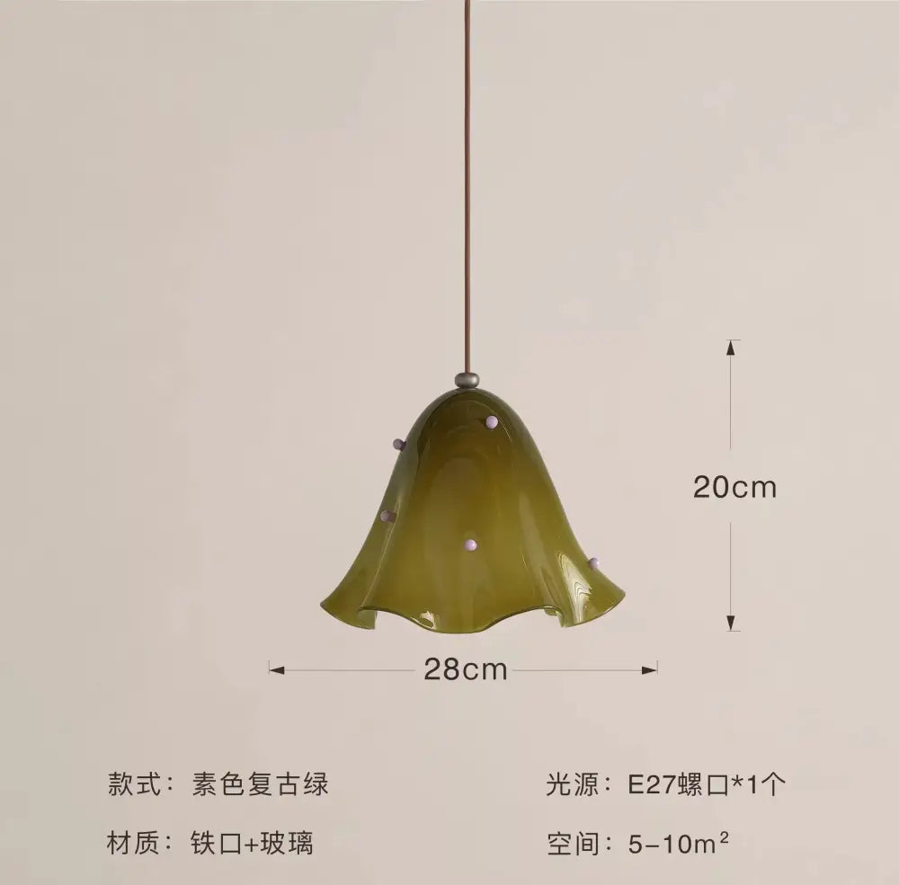 Olive-green glass pendant light with iron frame and white dots designed as a bell-shaped modern pendant light