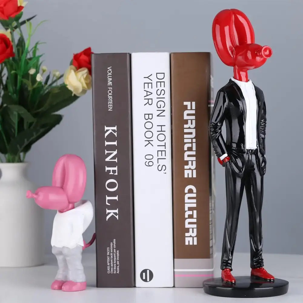 Red balloon dog statue in glossy resin dressed in black suit with red shoes for modern living room decor