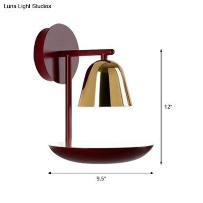 Modern wall light with a matte burgundy circular backplate and polished brass red dome wall sconce for bedroom use
