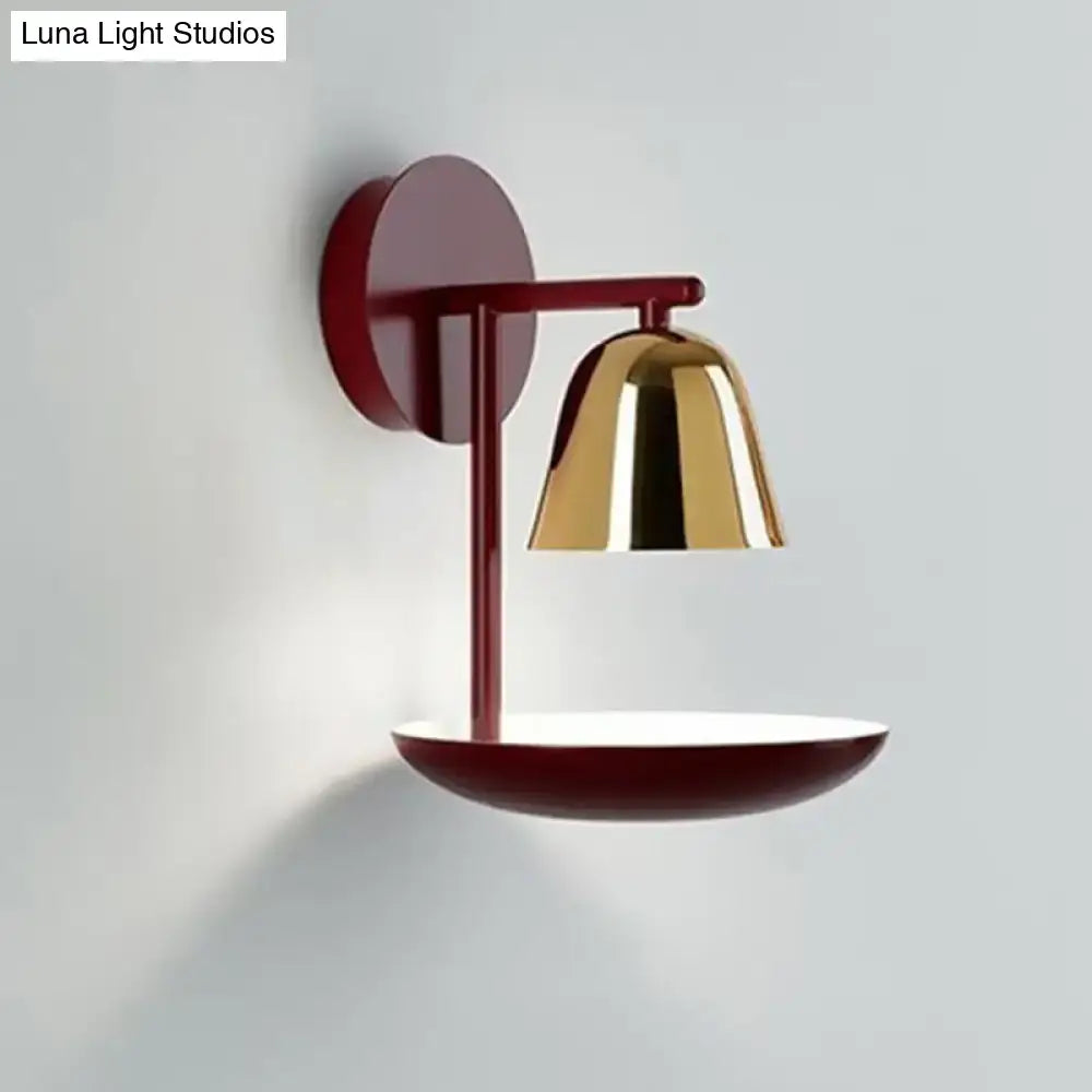 Modern wall light with a burgundy metal base and red dome polished gold shade for bedroom use