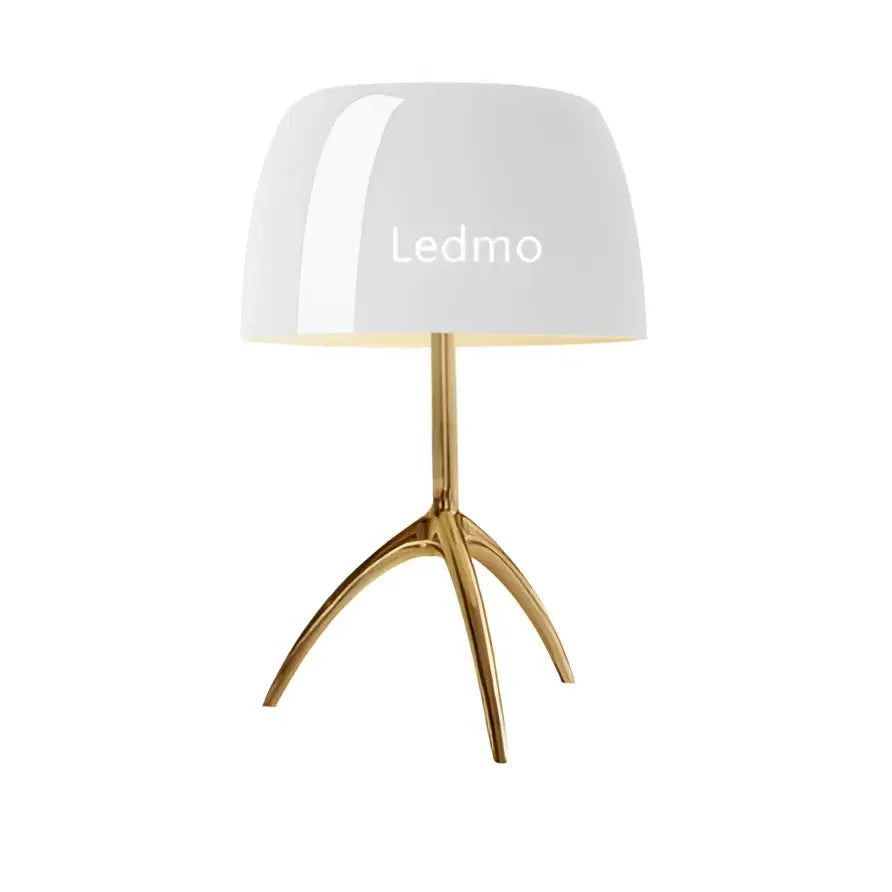 Modern table lamp with white glossy glass shade and gold-toned tripod base for bedroom use
