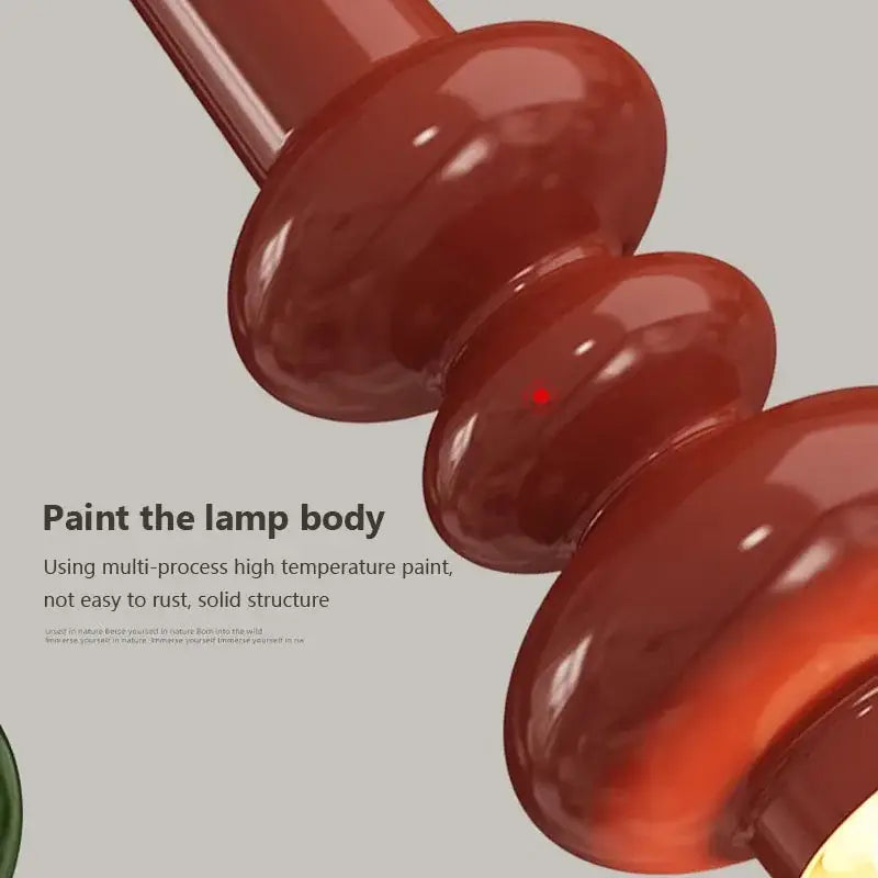 Modern red and green caterpillar iron led pendant light with a red glossy ceramic spiral lamp body decorbites caterpillar iron design
