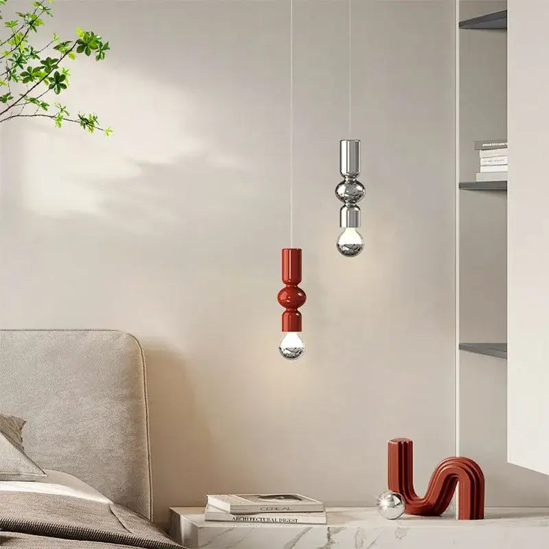 Two modern pendant lights with stacked spherical chrome and matte red designs from DecorBites caterpillar iron led collection