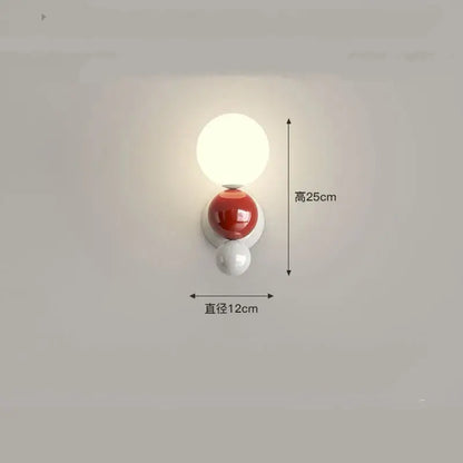 A modern decorbites led wall light with three spherical acrylic orbs in white, glossy red, and matte white for kids rooms