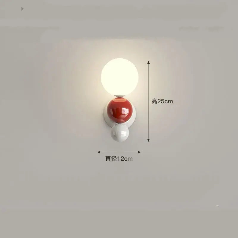 A modern decorbites led wall light with three spherical acrylic orbs in white, glossy red, and matte white for kids rooms