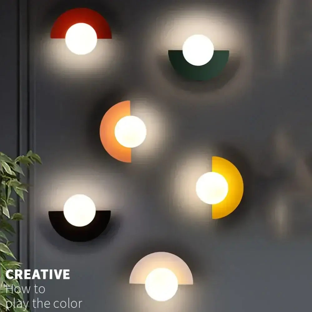 Modern red and orange glass ball led wall lamp with vibrant semi-circular decorbites glass ball sconces in metallic finish
