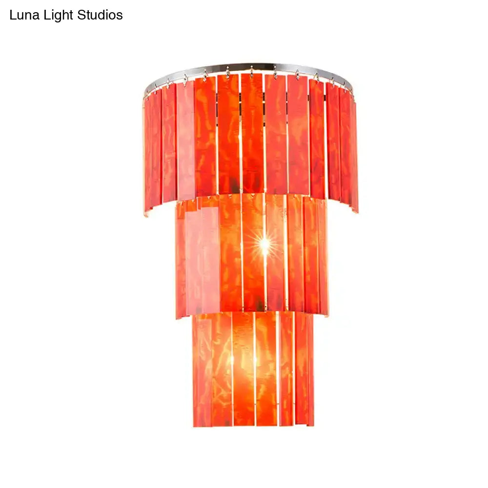 Modern red prism wall mounted light featuring vibrant orange translucent glass and a sleek chrome rim for living room use