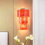 Modern red prism wall mounted light with vibrant tiered glass and sleek chrome rim for living room use