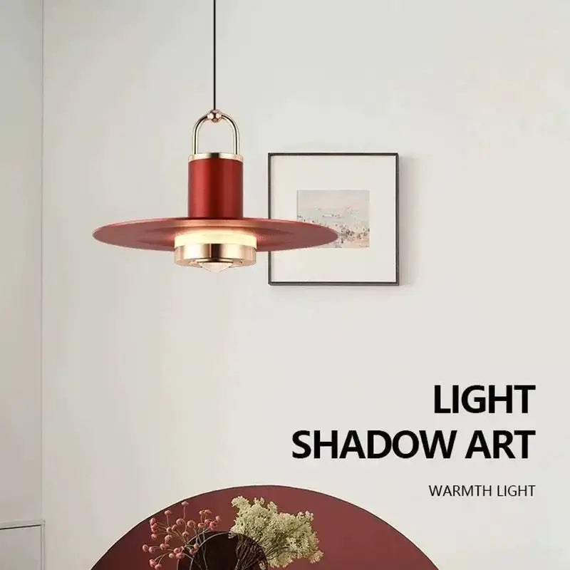 A modern red pendant lamp with gold-toned accents and a sleek circular shade for dining room decorbites colorful umbrella decor