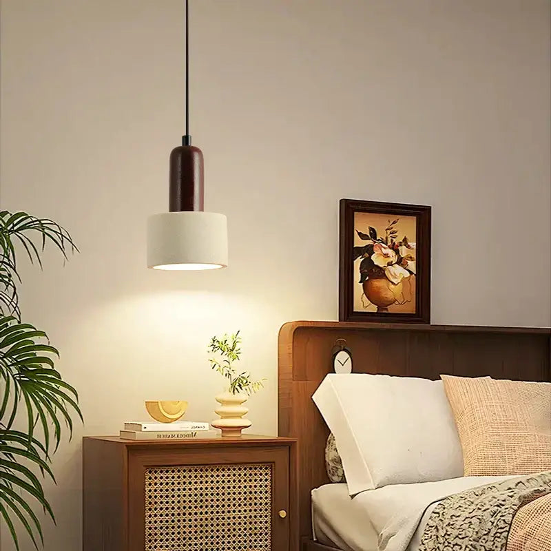 Modern reddish brown and cream decorbites cement cylinder led pendant with dark wood top and white shade hanging by black cord