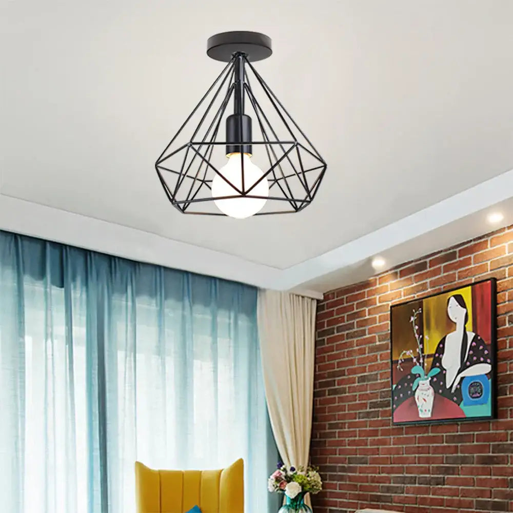 Modern retro black iron cage ceiling light with geometric wireframe design featuring a central bulb for kitchen lighting