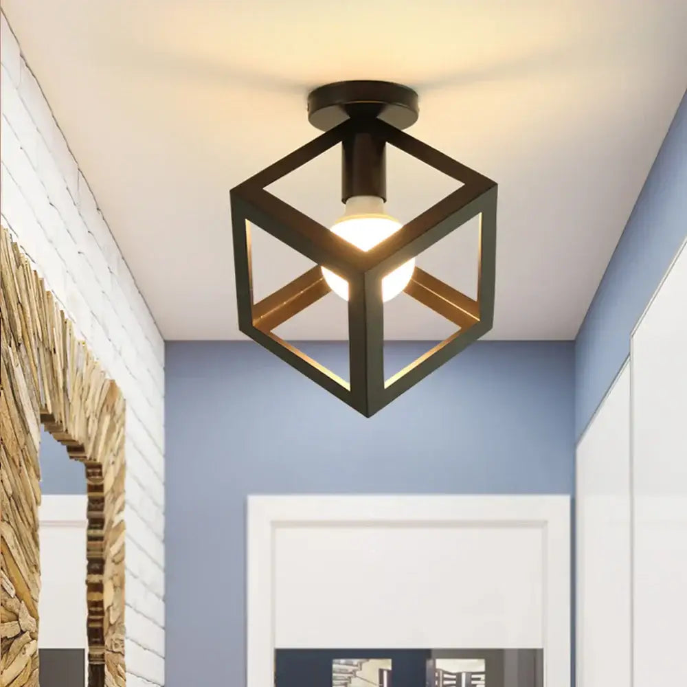 Modern retro black iron cage ceiling light with warm glow featuring a geometric cube design for kitchen lighting decorbites iron cage