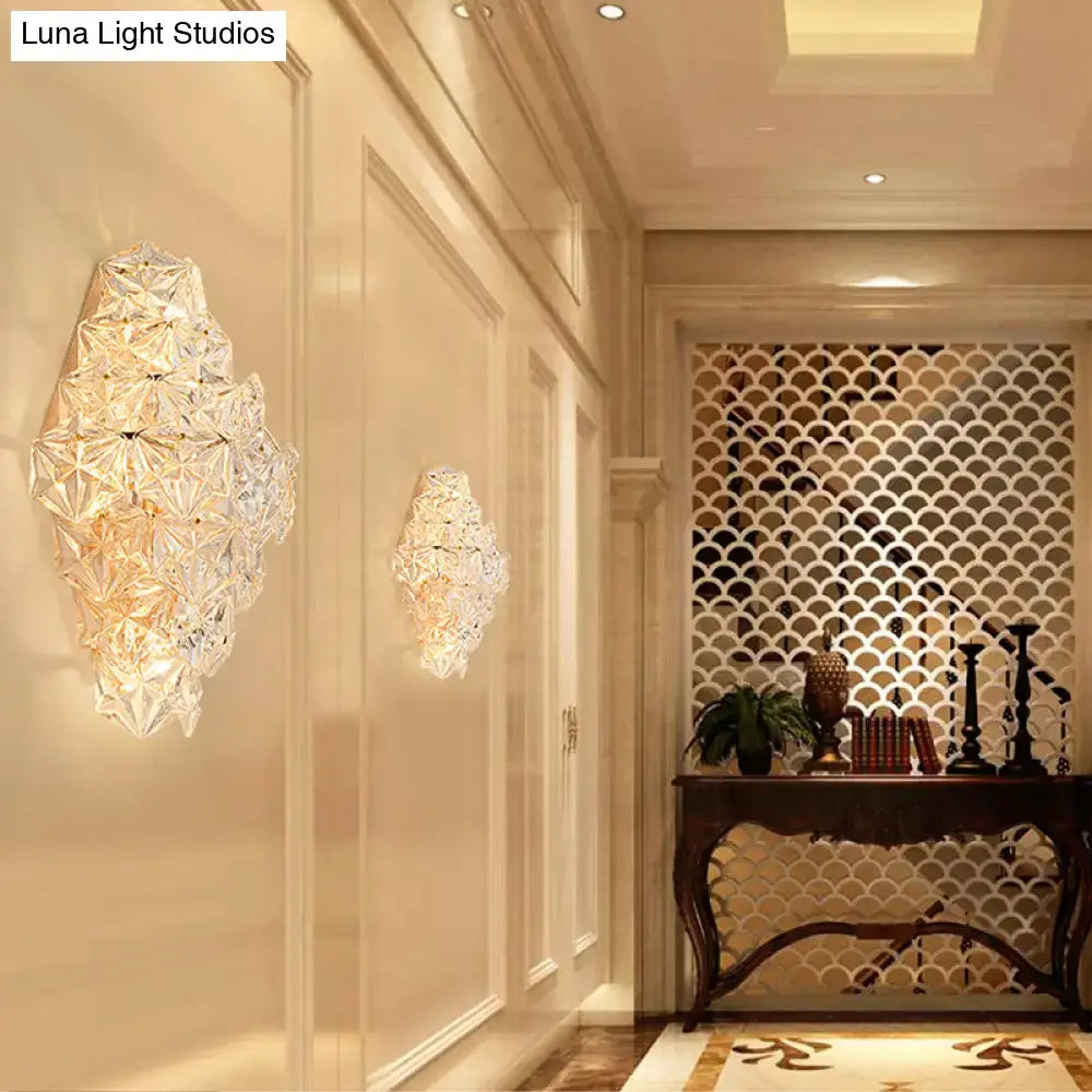 Modern rhombus clear crystal wall sconce with faceted diamond-like design and warm golden direct wired electric light type
