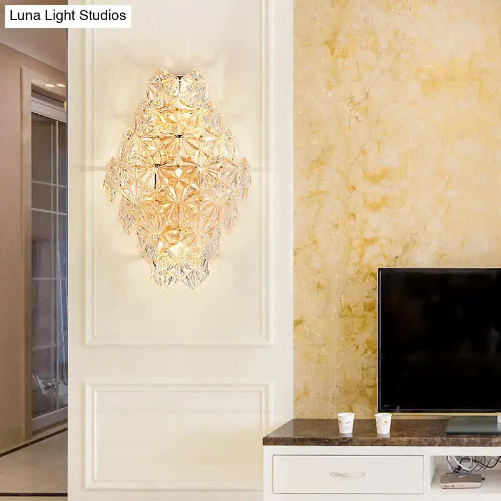 Modern rhombus clear crystal wall sconce with faceted glass segments in cascading design direct wired electric light type