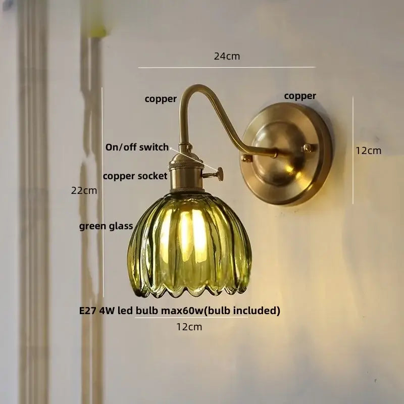 A vintage-style wall sconce with a ribbed green glass copper led shade and brass copper finish for bedroom use
