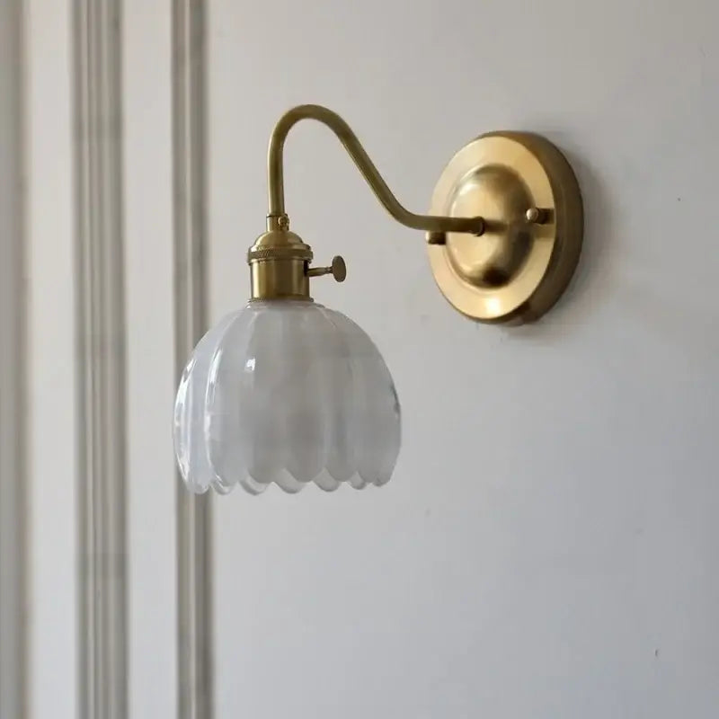 A vintage-style brass wall sconce with a translucent scalloped glass shade copper led wall lamp for bedroom use