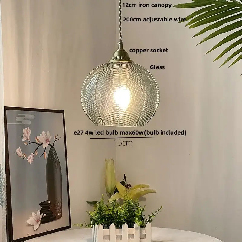Modern ribbed decorbites blue glass led pendant light with textured spherical shade and antique brass socket for kitchens