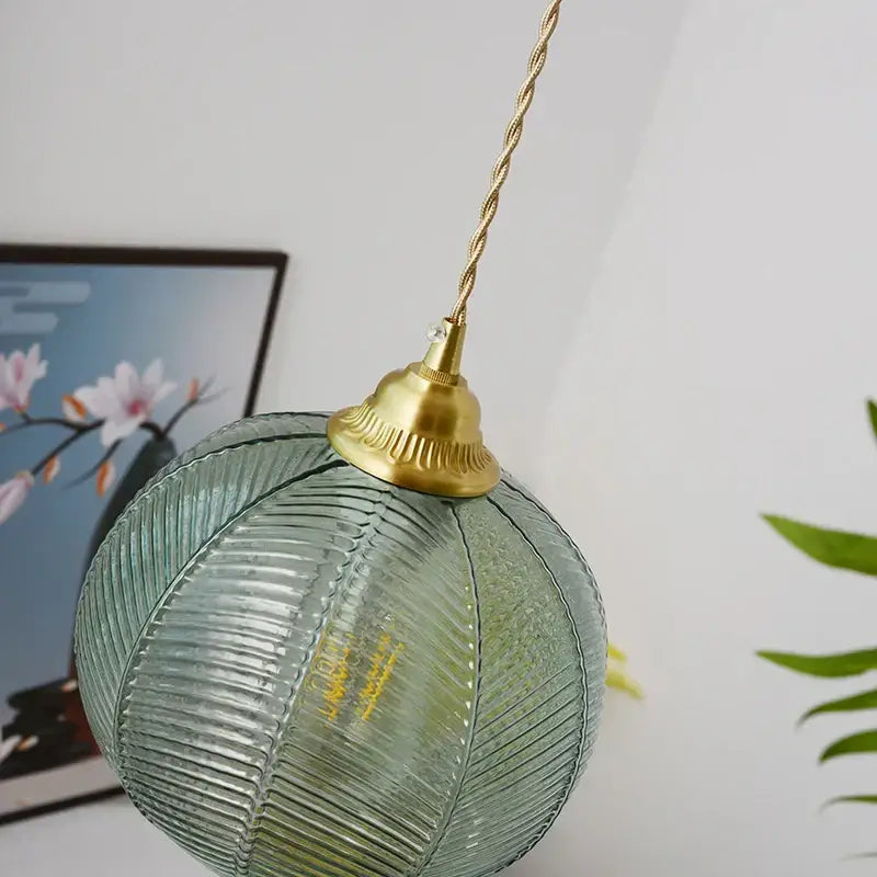 Modern ribbed blue glass LED pendant light with textured spherical shade and brass finish for kitchen decorbites pendant light