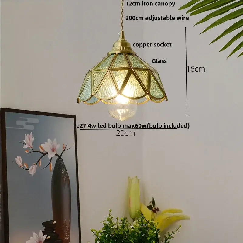 A vintage-style brass pendant light with faceted green glass shade and adjustable copper socket for decorbites blue glass decor