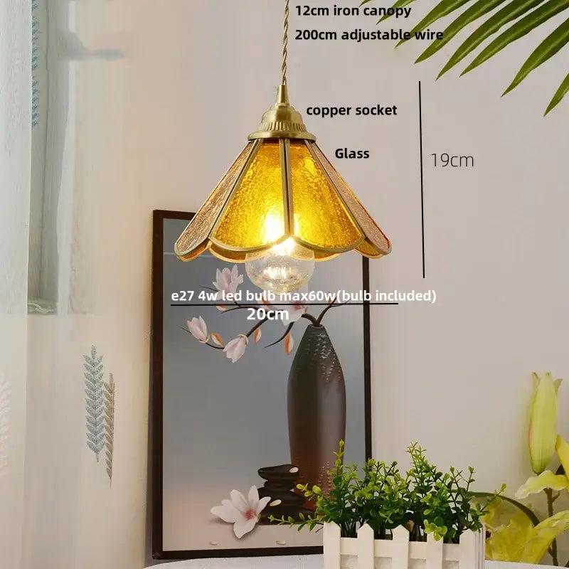A warm amber glass pendant light with brass canopy and copper socket featuring adjustable wire suspension decorbites blue glass