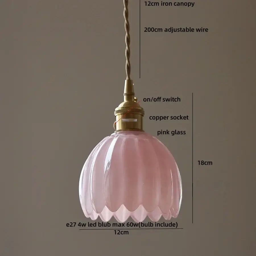 A delicate pink glass pendant light with fluted design and brass fittings beside modern ribbed blue glass pendant light decorbites blue glass