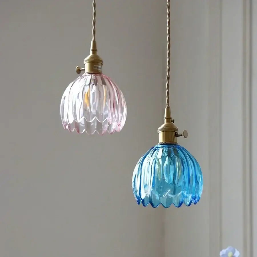 Two vintage-style pendant lights with ribbed pink and blue glass shades hung from twisted brass cords for dining decorbites blue glass led