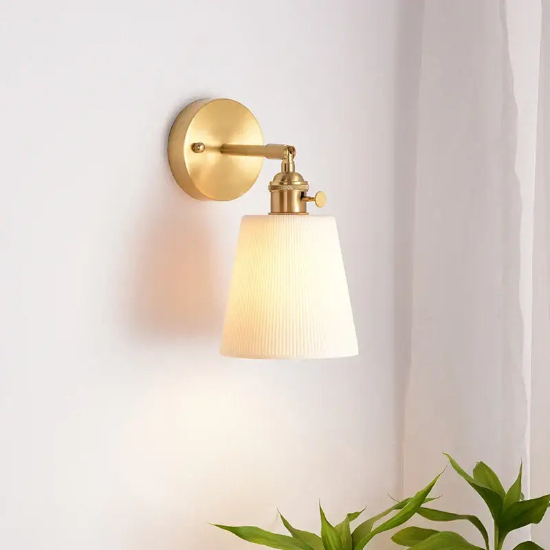 Modern ribbed ceramic led wall light with gold-toned brass pull chain and off-white glass shade for bedroom decorbites ceramic led wall