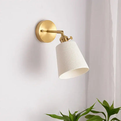 Gold-finished wall light with a white ribbed fabric shade and brass pull chain from decorbites ceramic led wall collection