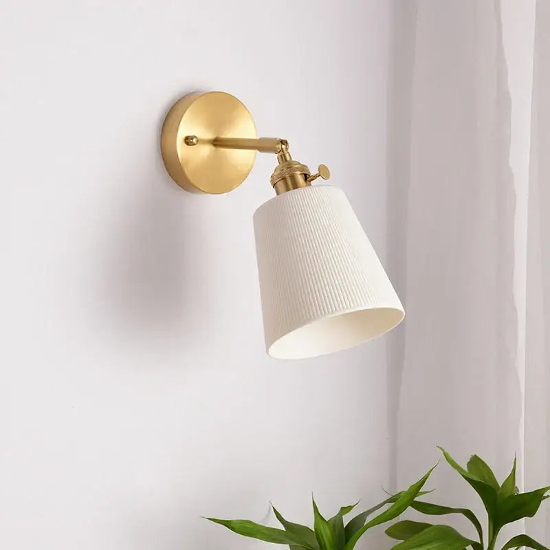 Gold-finished wall light with a white ribbed fabric shade and brass pull chain from decorbites ceramic led wall collection