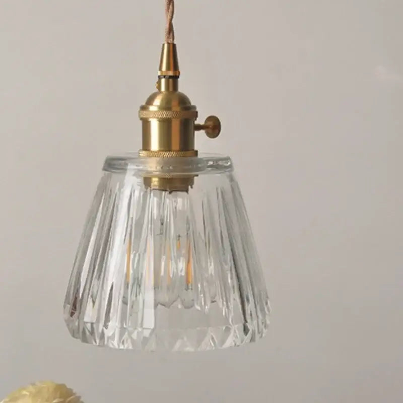 Modern ribbed clear glass led pendant light with brass fixture featuring a clear glass decorbites pendant light design