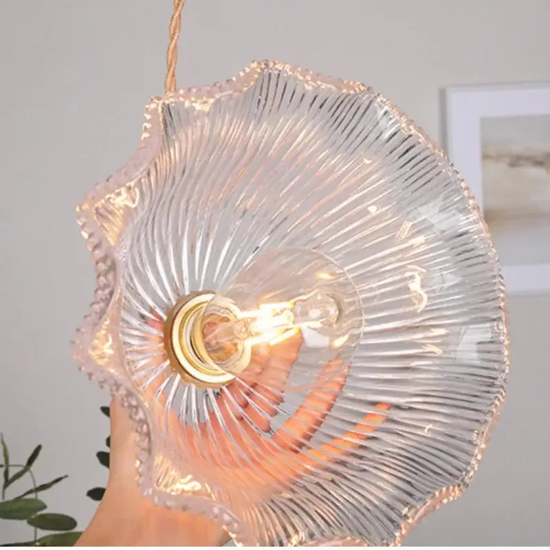 Modern ribbed clear glass pendant light with gold-toned bulb holder and exposed filament bulb by decorbites clear glass