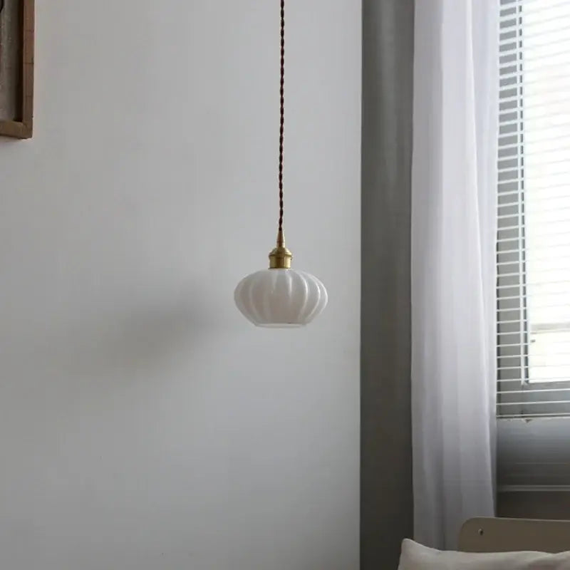 Modern ribbed copper white glass pendant lamp with brass fixture and braided cord for stylish living room decorbites decor