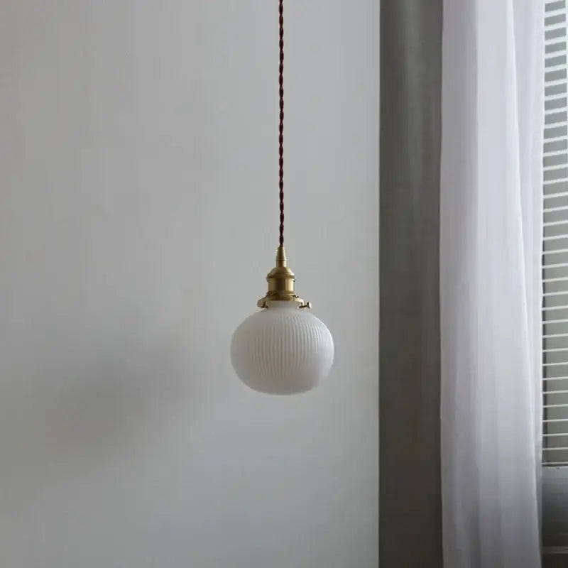 Modern ribbed copper white glass pendant lamp with brass fixture and braided brown cord for living room decorbites decor
