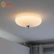 Modern ribbed cream glass round ceiling lights featuring warm-toned ribbed glass and sleek chrome fixture for bedroom decor